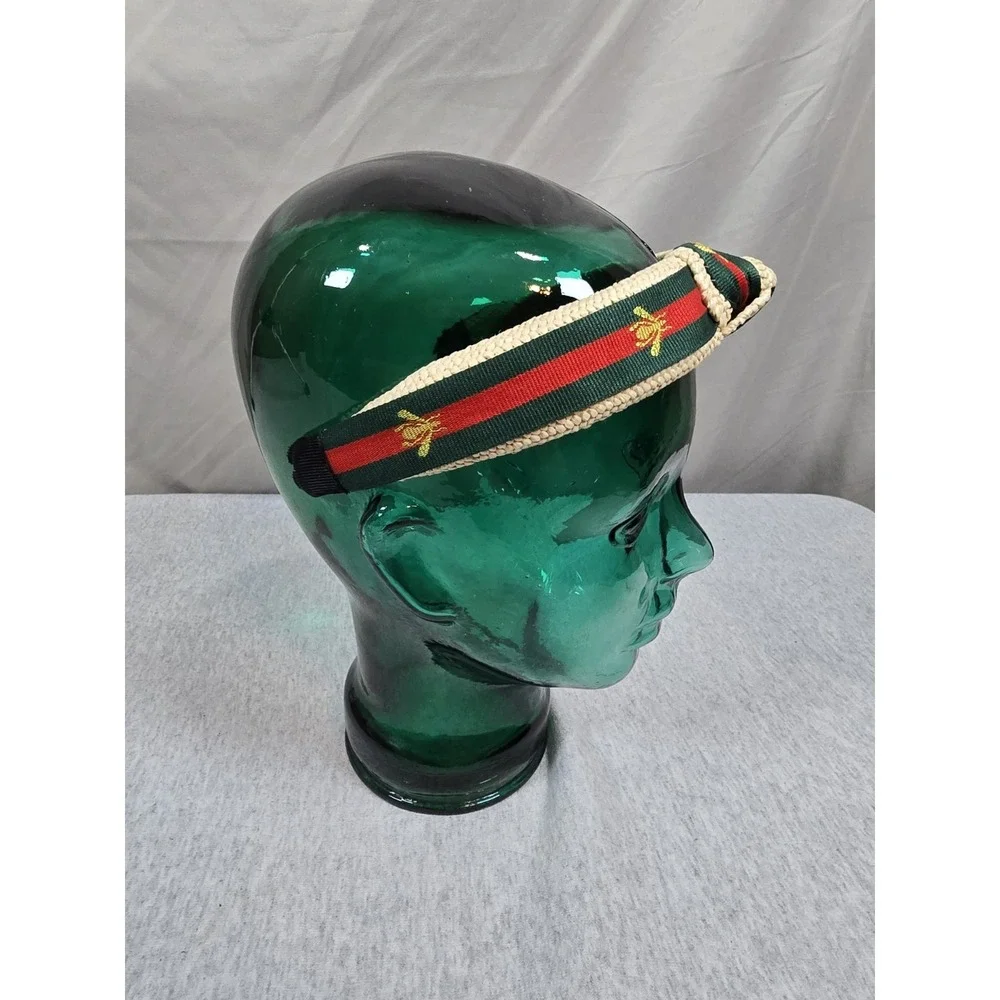 Bee Headband woven straw top-knot headband featuring a red and green striped...